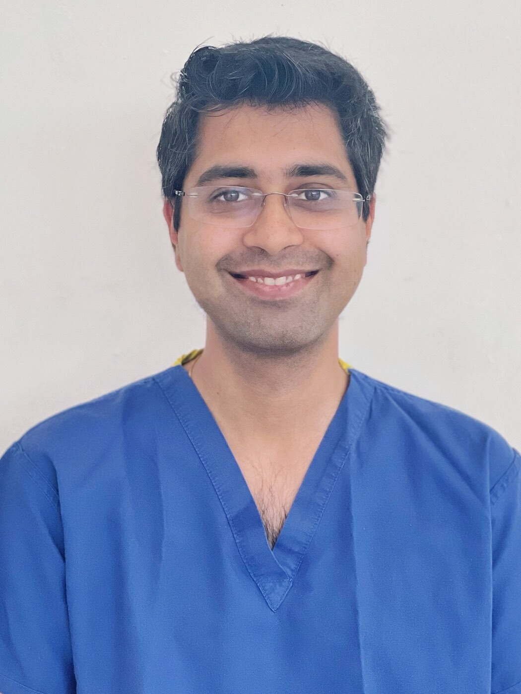Dr Aditya Malik, orthopaedic surgeon, photographed in surgical scrubs