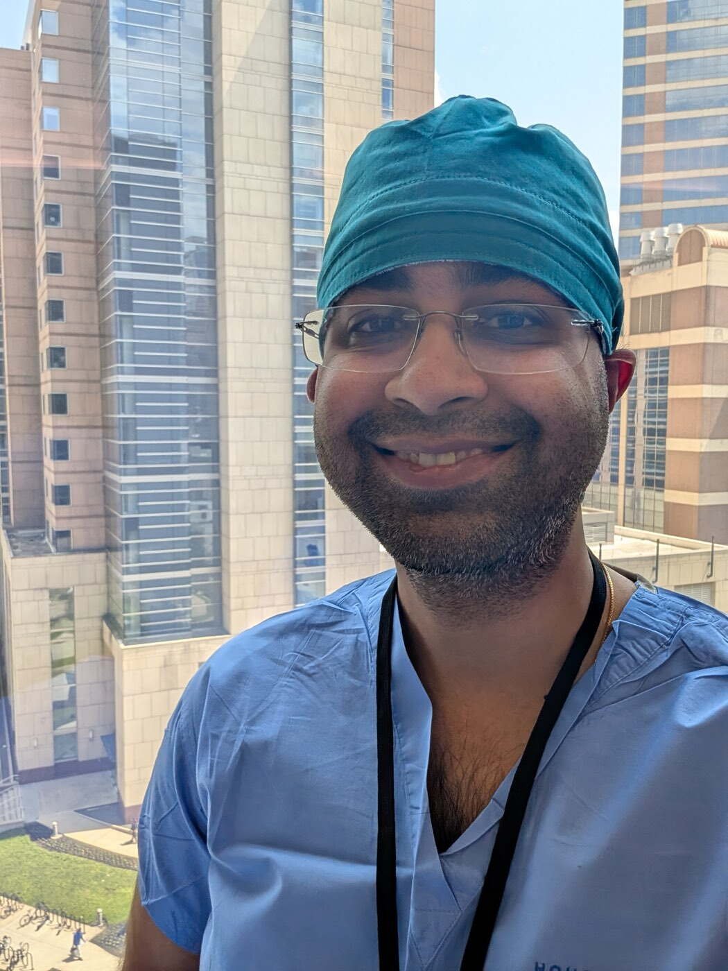Dr Aditya Malik in surgical scrubs and theatre cap